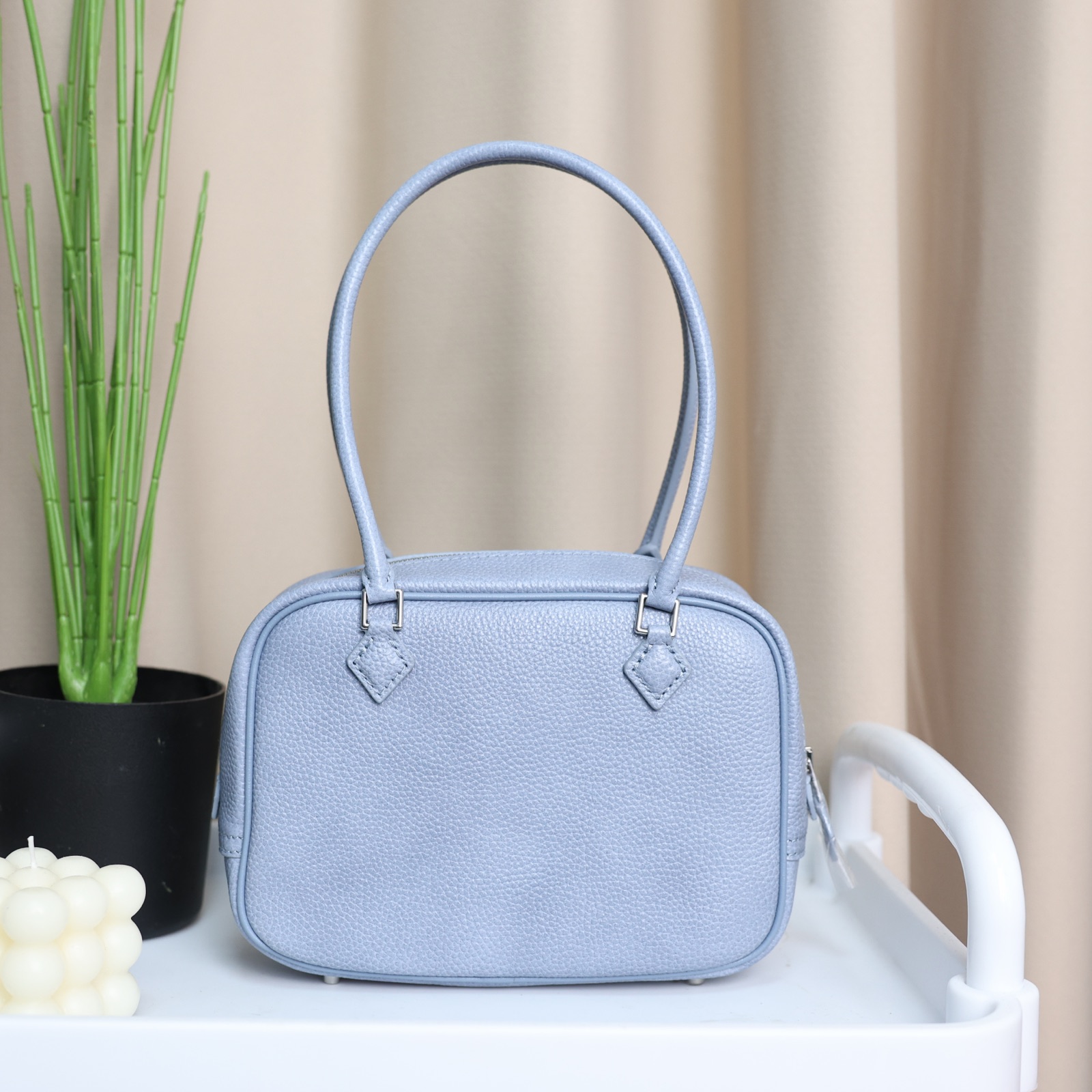 Powder blue carryall photographed in a sunlit interior